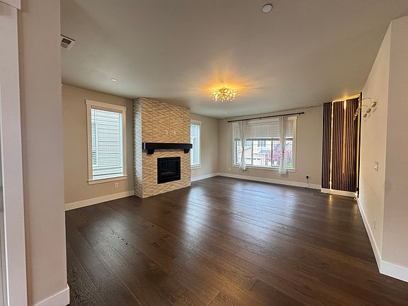Living Room with fire place, modern lighting fixtures for relaxation and hosting