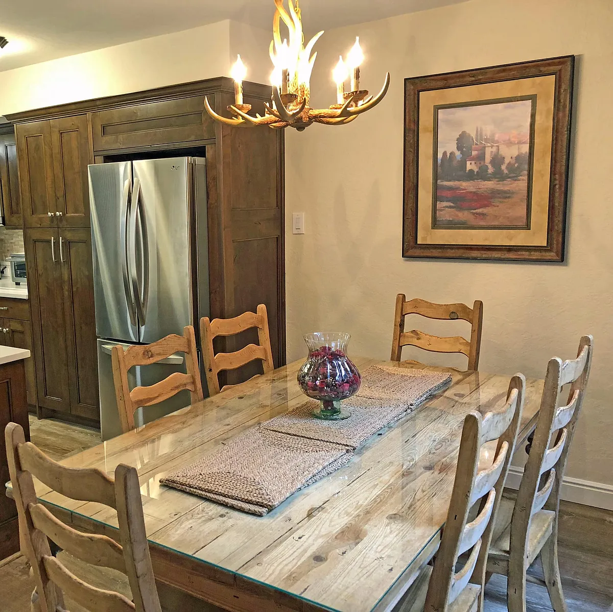 This is the dining area shown and part of the kitchen, with a stainless steel French Door LG refrigerator. - 1783 Captain Molly Dr