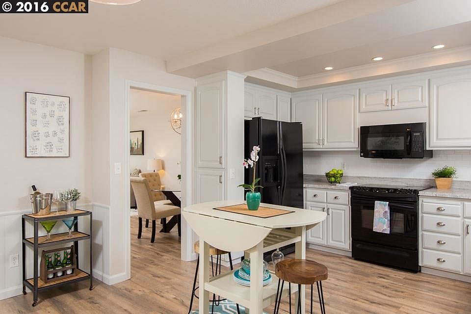 New River White Granite counters and Subway backsplash. Kitchen family combo opens to patio