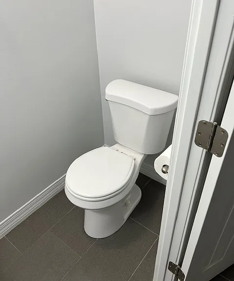 First floor .5, one half Bathroom Powder Room: Toilet, New Toilet Seat, Exhaust Fan with added Light, Tile and Grout Flooring, Freshly Painted Ceiling, Walls, Baseboards and Moldings.