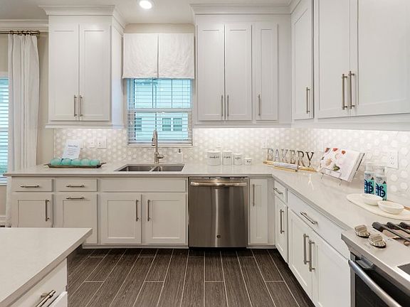 Located on the second floor, this charming kitchen includes a large center island with granite count