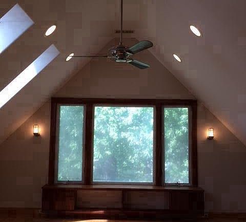 Large Living room with built-in bookshelf under picture window