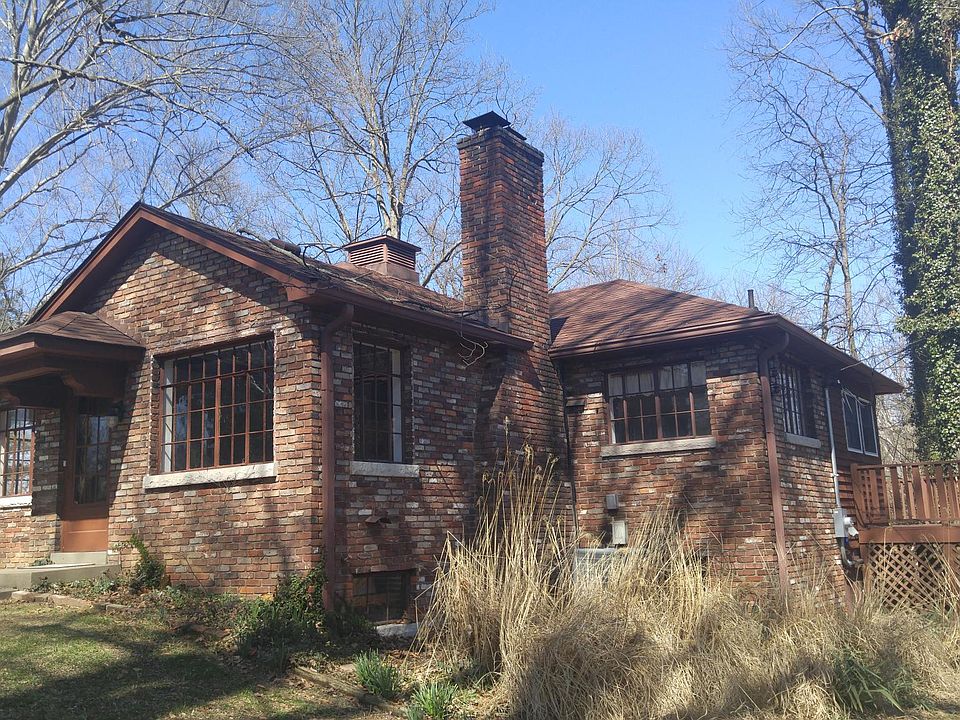 Brick cottage nestled in the trees with view of Silver Creek.