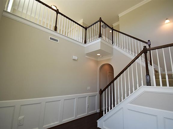 Two story foyer with wainscoting