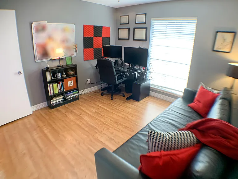 Bedroom has a clean, grey aesthetic and includes a large double-door closet.