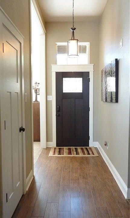 Foyer shows new doors, casings and tall baseboards. Two coat closets, too.