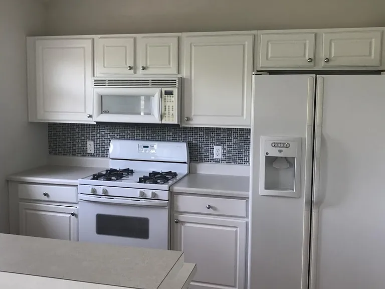 All-white kitchen, the white fridge was replaced after this photo with a stainless steel one
