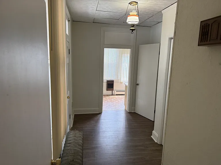 foyer at front door looking into kitchen