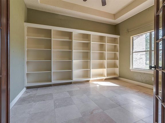 Off of the foyer is a gorgeous office with wall to wall bookcases & gorgeous ceilings.