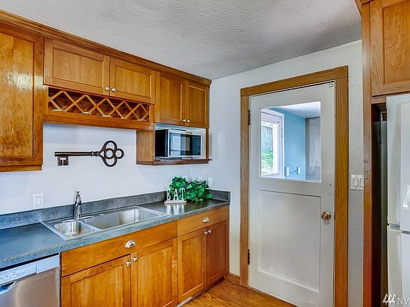 Kitchen leads to laundry/mudroom and backyard!