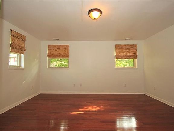 The Master bedroom is very spacious with beautiful hardwood flooring and multiple windows that shower the room in natural light!
