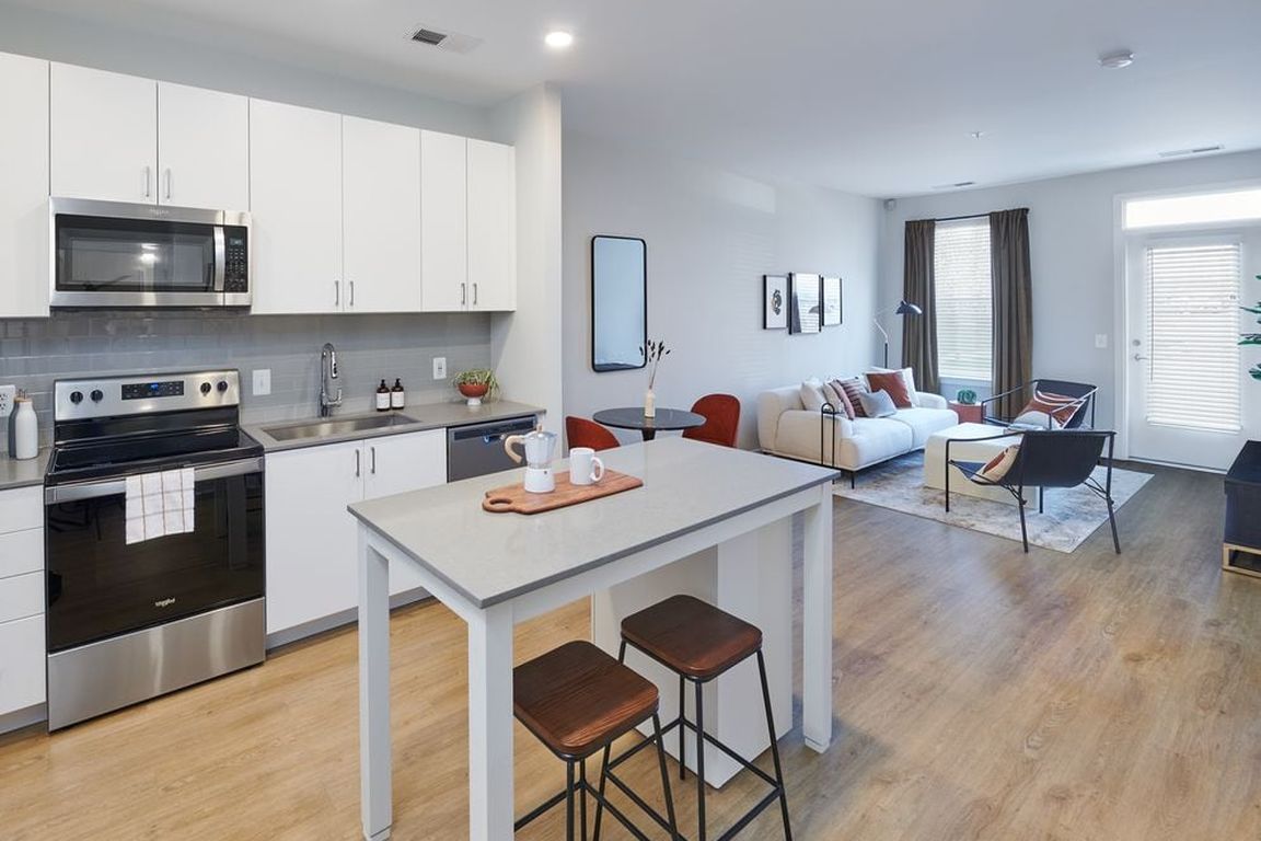 Design Collection II kitchen, living, and dining areas with hard surface flooring throughout