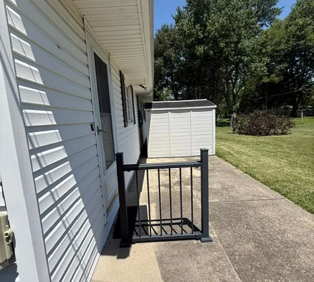 Side view of the back yard including view of the storage shed