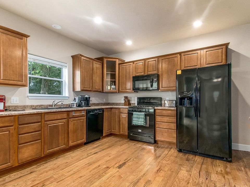 Large, spacious kitchen, granite countertops, hard wood floors, natural light.