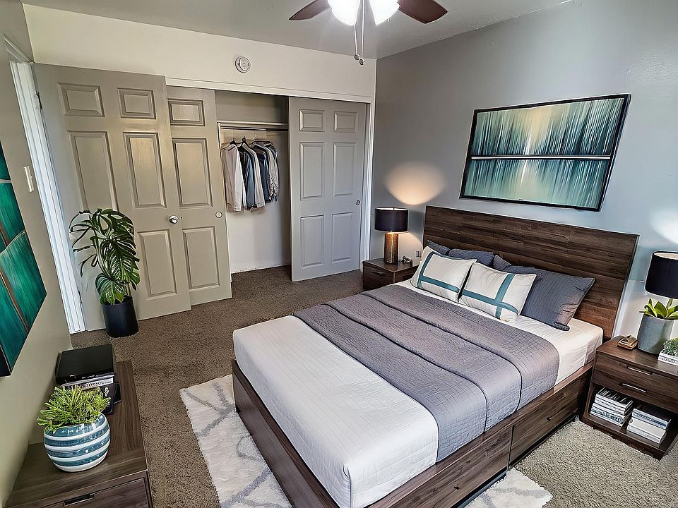 Elegant bedroom showcasing a modern design with a comfortable bed, chic decor, and ample closet space, illuminated by soft natural light.