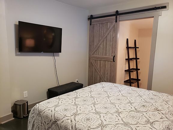 Master suite with barndoor entry to master bathroom