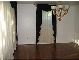 Dining Room iwth window seat and hardwood floors.