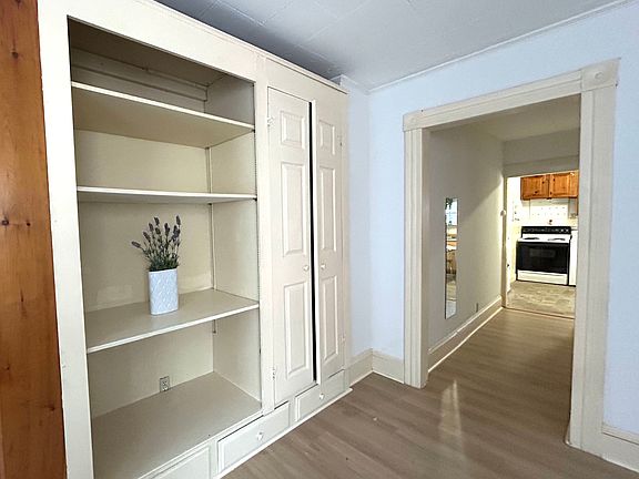 View from the living room to the kitchen. A hallway door to the right is the bedroom entrance