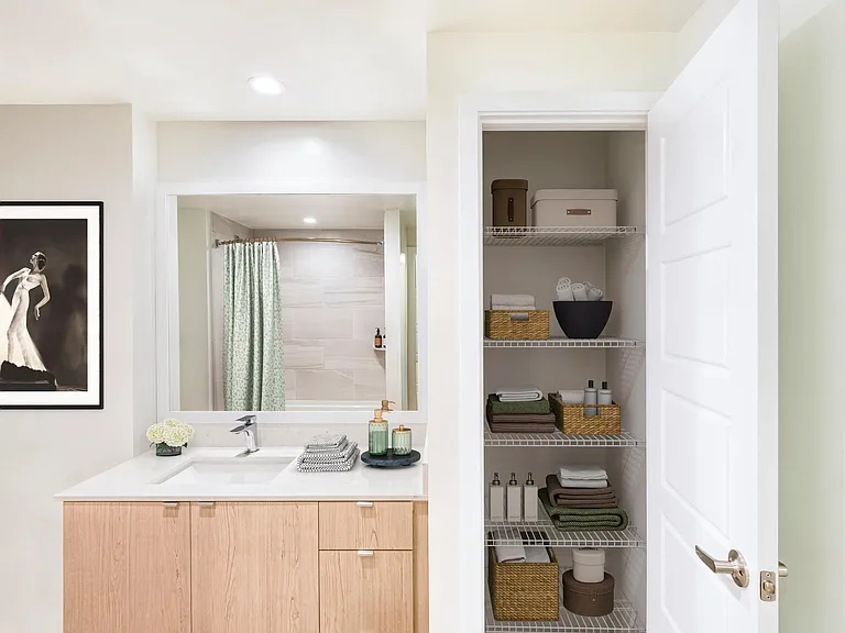 Bathrooms at Modera Aventura feature sleek vanities and convenient linen storage for everyday ease.