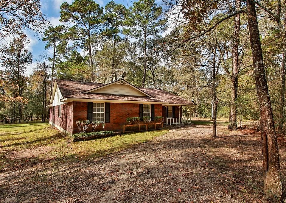 Ranch style home hidden behind the trees.  Home is not visible from the street.