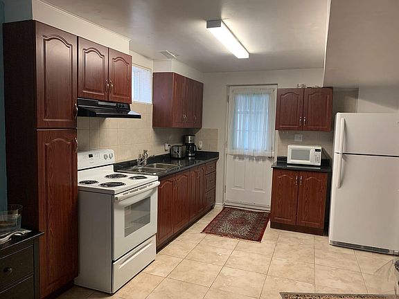 Kitchen. 5 energy efficient appliances provided: New Fridge/Freezer, new stove, Washer, Dryer, Microwave. This is a open concept kitchen and has enough space for a large living room where you can have a cozy corner for relaxing and watching TV and also s