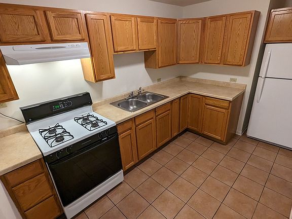 Remodeled kitchen with gas stove and refrigerator