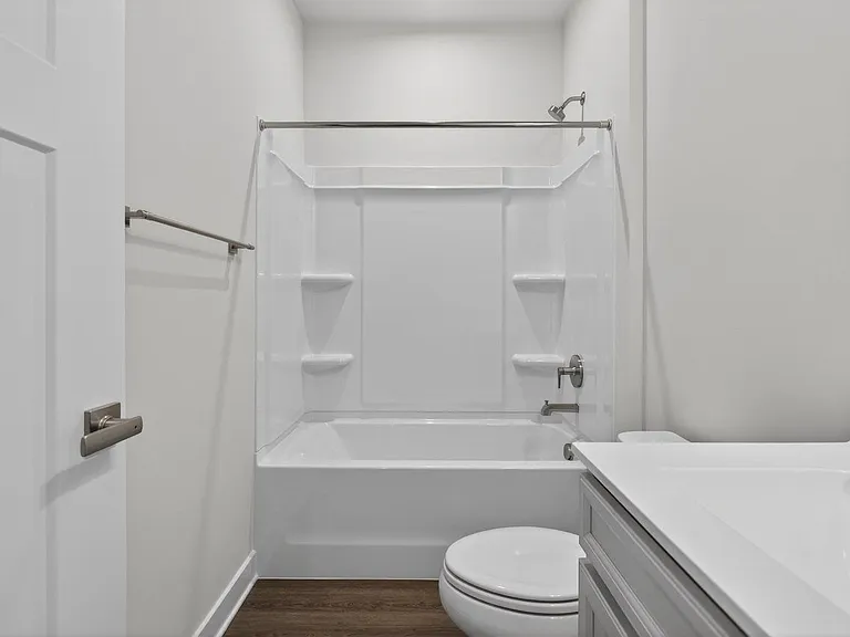 Hall bathroom with a tub/shower cultured marble countertops and LVP flooring