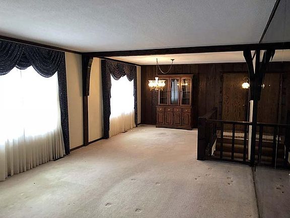 Another view of the living room and dining room toward the front windows.