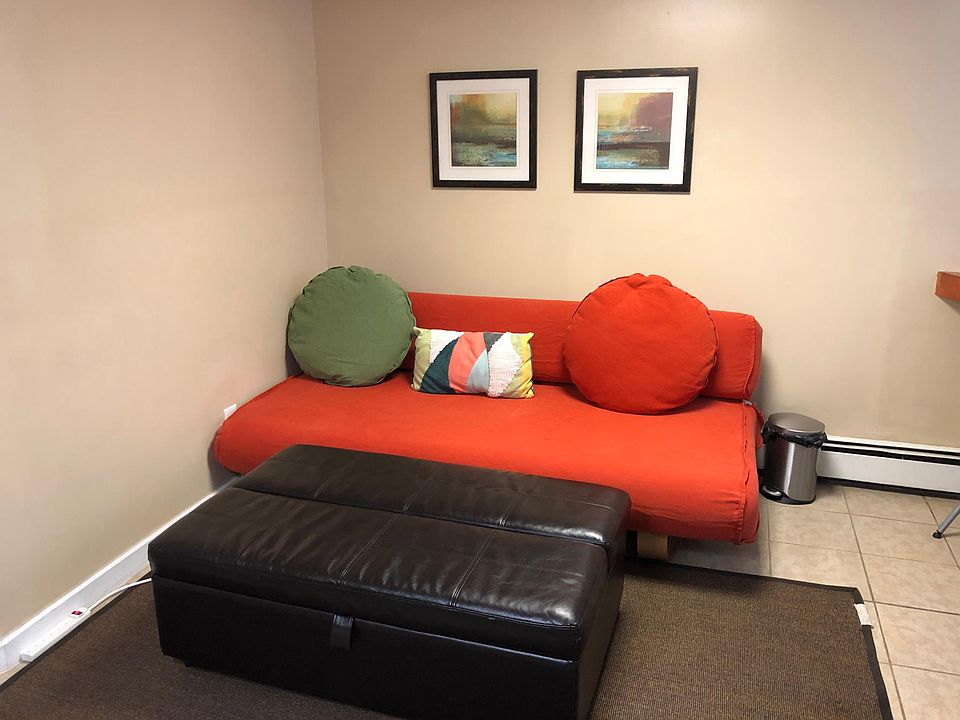 Spacious living room where large red sofa, ottoman and large area rug can easily fit (furniture not included, shown here for illustration purpose only)