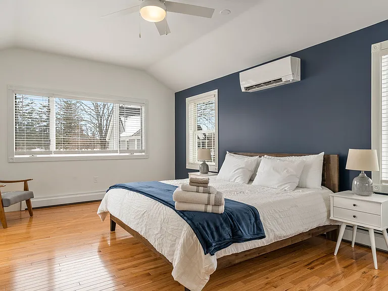 Accent Wall (Navy) Large Windows Mini-Split A/C Unit Vaulted Ceiling Ceiling Fan Ample Natural Light Mid-Century Modern Furniture