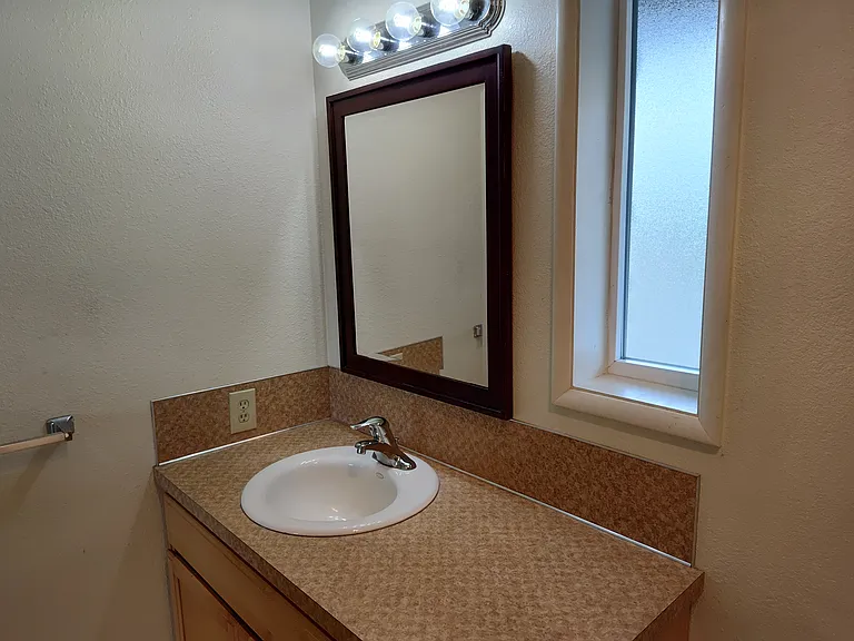 Well lit bathroom with a large linen closet