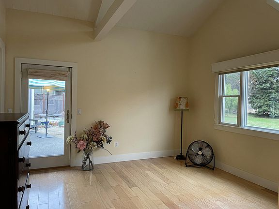 master bedroom with natural light and vaulted ceiling