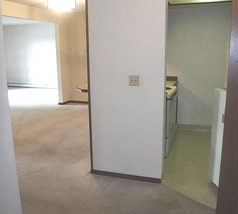 View from entry door into kitchen and left side dining room/living room