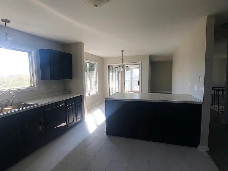 Kitchen looking into dining and sunroom.