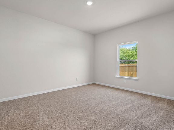 The master bedroom is spacious and has a large window.