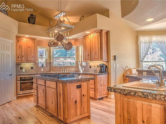 Gourmet kitchen, knotty hickory floor and cabinets, granite, large breakfast bar