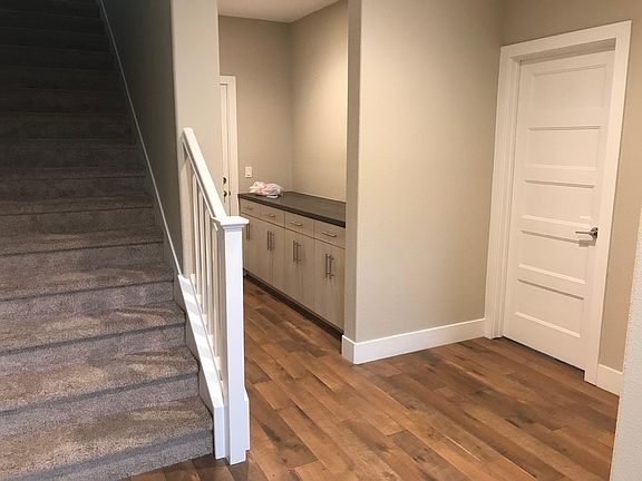 Entrance with stair to 2nd floor where the center of the home is with kitchen, patio, living and dining room. The hall is to the garage and the door is to the first floor bedroom with private bath.