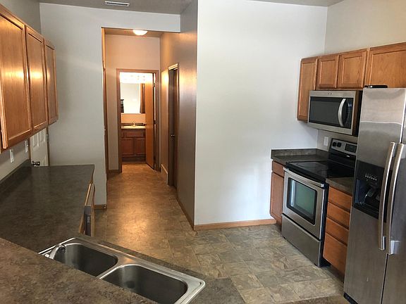 Kitchen, hallway closet, storage room, and half bath