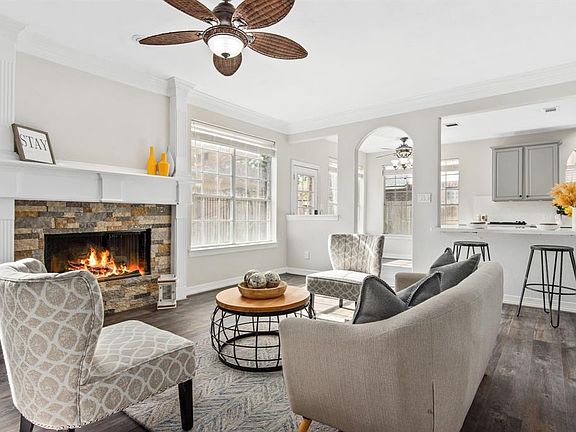 The heart of the home, the family room, is anchored by the beauty of the gas fireplace, framed by multi-colored stone.