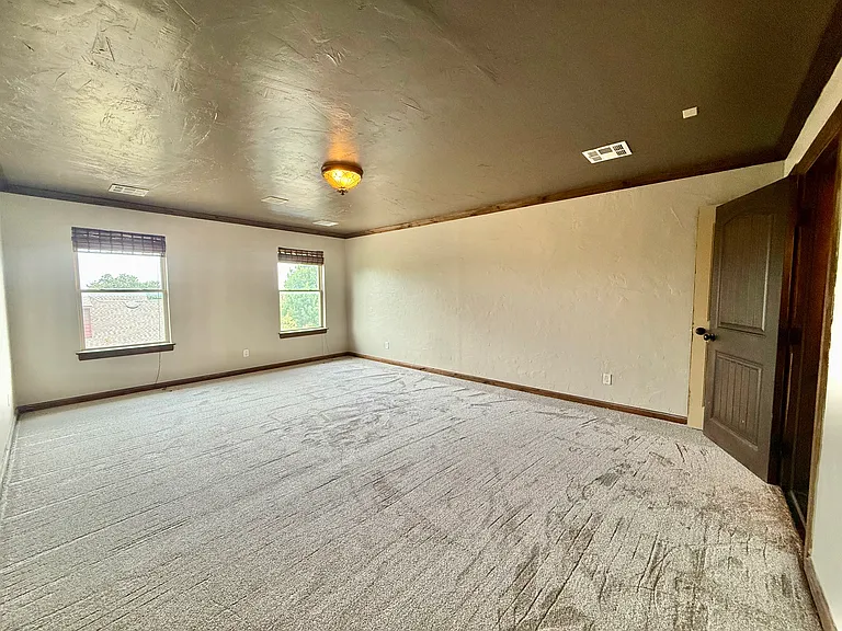 Welcome to the 5th bedroom. Natural light with brand new carpet and paint. Has a separate air conditioner unit and its own closet. Use as a bedroom, game room, playroom, man cave, she cave and/or whatever is in your imagination.