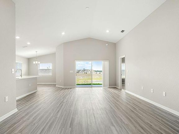 This home features a sunny, open living area with volume ceilings - Sophia by Highland Homes