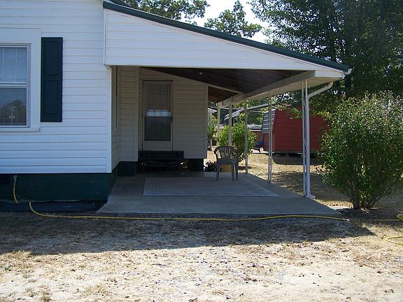 Carport with entrance to house