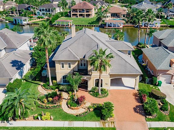 Park your boat at your back door with this luxury home on the water. Notice anything? Upgraded driveway and walkway to the front door.... are BEAUTIFUL! This home is truly the crowning jewel of the street!