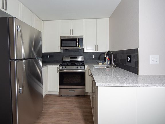 Beautiful kitchen with quartz countertops and stainless steel appliances.