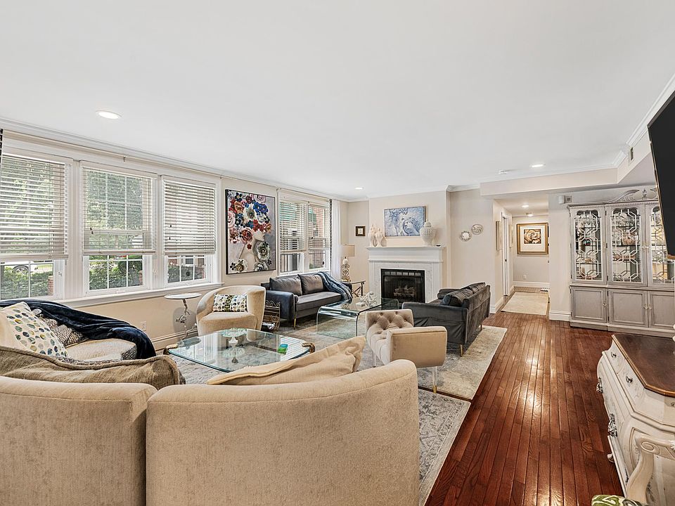 Abundant natural lighting in living area. Large screen TV mounted on wall.