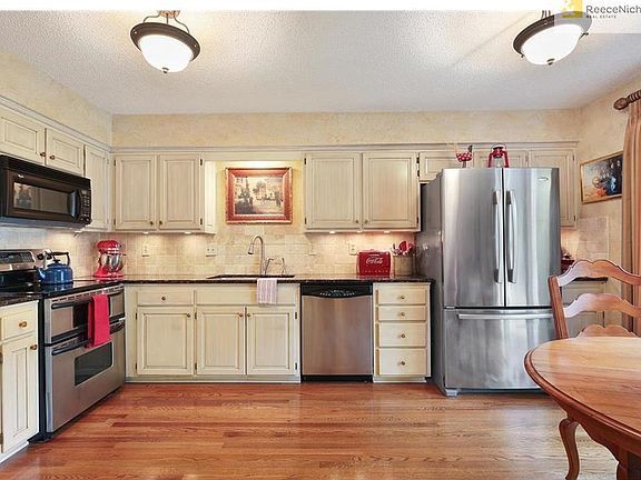 White cabinets, granite tops and stainless appliances in large Kitchen