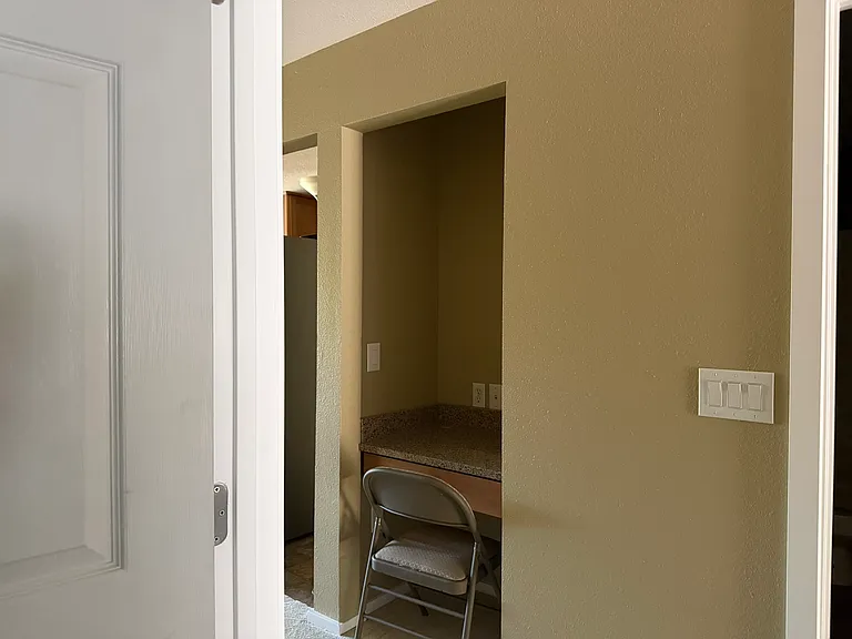 small desk in hallway near kitchen