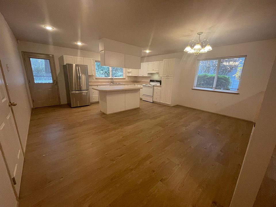 Kitchen with new fridge and dishwasher...not to mention the new water heater in the garage. All new paint and carpet, and Hard surface flooring.