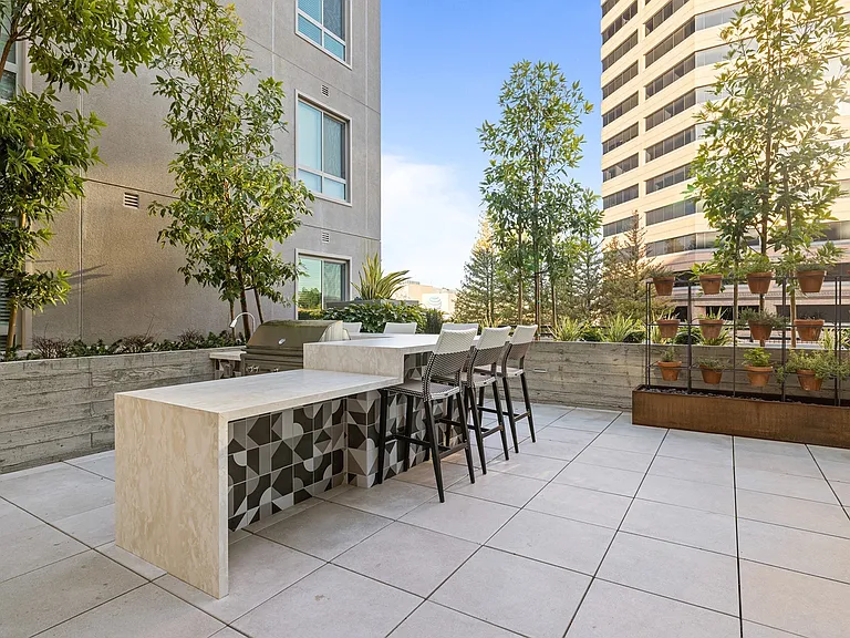 Enjoy outdoor dining with bar seating, a built-in grill, and fresh herbs just steps away.