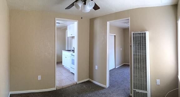 Other half of the living room. Bedroom door on the right, kitchen door on the left.
